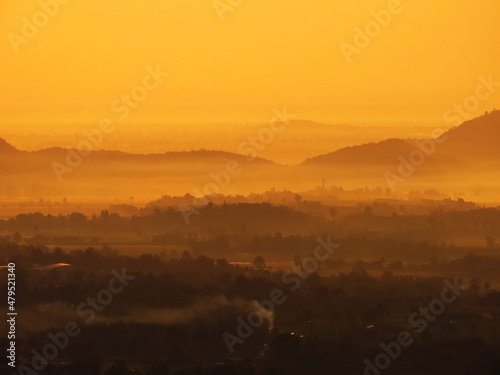 Amazing Sunrise Over Misty Landscape. Scenic View Of Foggy Morning Sky With Rising Sun Above Misty Forest © khlongwangchao