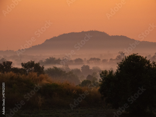 Amazing Sunrise Over Misty Landscape. Scenic View Of Foggy Morning Sky With Rising Sun Above Misty Forest