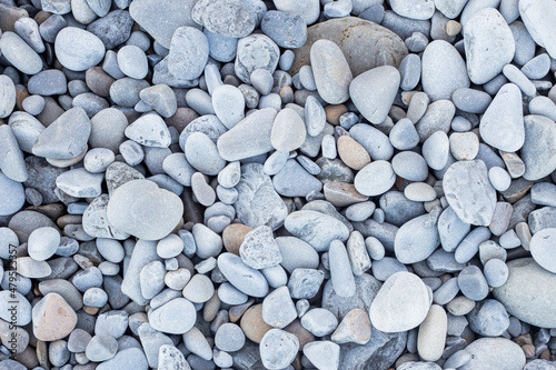 dry pebbles at the seashore in different shades of grey and ochre. stones symbolising strength and endurance. stone background. zen background.
