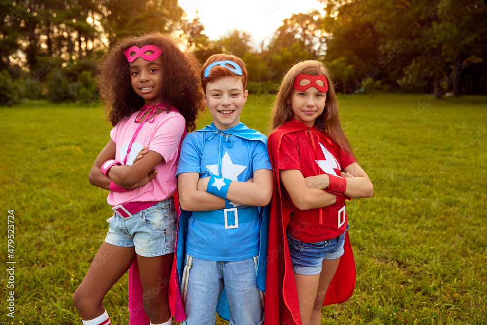 Fototapeta premium Company of diverse kids in superhero costumes
