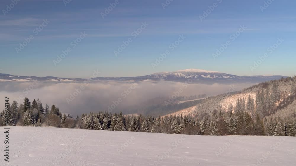 Beautiful view over winter landscape with trees, cloud inversion in distance and mountain Beautiful view over winter landscape with trees, cloud inversion in distance and mountain