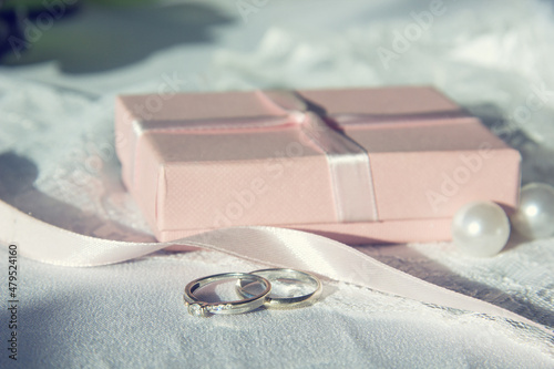 Selective focus. The wedding ringson the lace with ribbons and beads. Wedding preparations for the celebration. photo