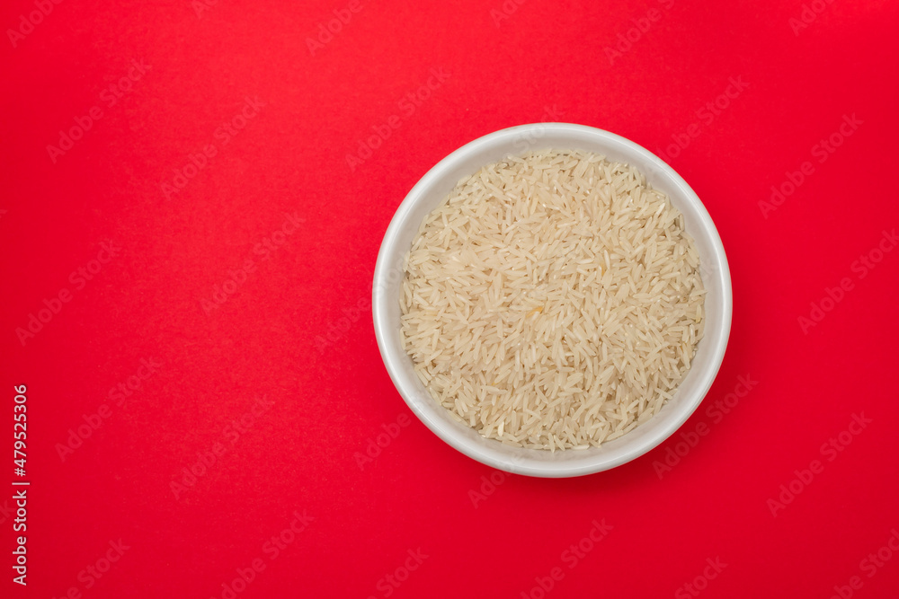 raw rice on white bowl on gray ceramic raw rice on white bowl on gray ceramic