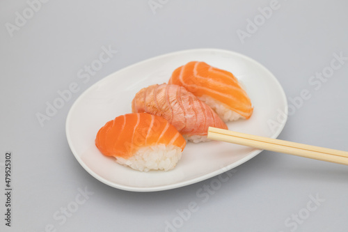 Assorted sushi on small white dish top view
