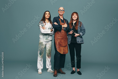 Diverse women from different creative occupations standing in a studio photo