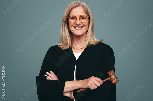 Successful female judge smiling at the camera in a studio photo