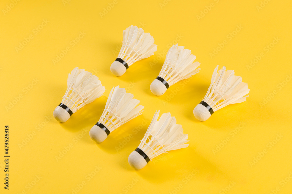 Badminton shuttlecock isolated on yellow background Badminton shuttlecock isolated on yellow background