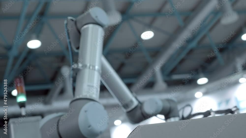 A robot arm uses vacuum suction cups to transport cardboard boxes to the desired location