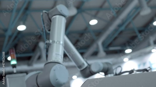 A robot arm uses vacuum suction cups to transport cardboard boxes to the desired location