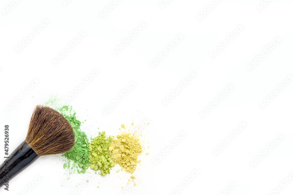 Colorful eye shadow, crushed cosmetic isolated on white background with brush. A smashed, bright toned eyeshadow make up palette Colorful eye shadow, crushed cosmetic isolated on white background with brush. A smashed, bright toned eyeshadow make up palette