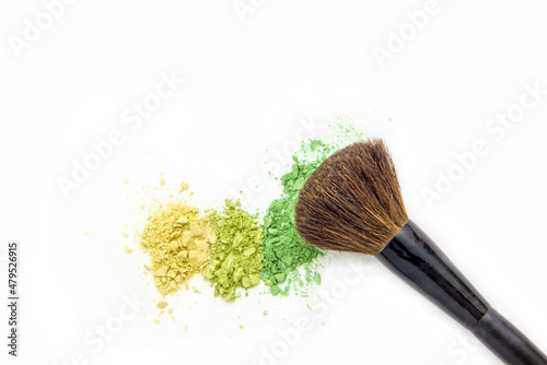 Colorful eye shadow, crushed cosmetic isolated on white background with brush. A smashed, bright toned eyeshadow make up palette