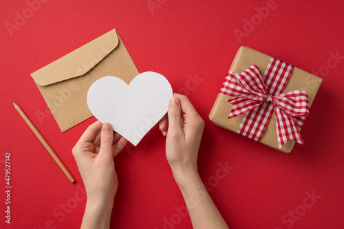 Fotografija First person top view photo of valentine's day decor girl's hands holding paper