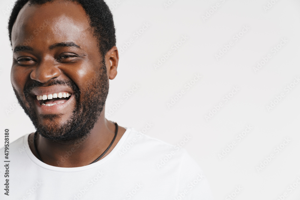 Fototapeta premium Black bristle man laughing while looking at camera