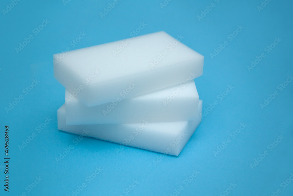 Melamine sponges on a bright blue background. The concept of home cleanliness and cleaning. Melamine sponges on a bright blue background. The concept of home cleanliness and cleaning.