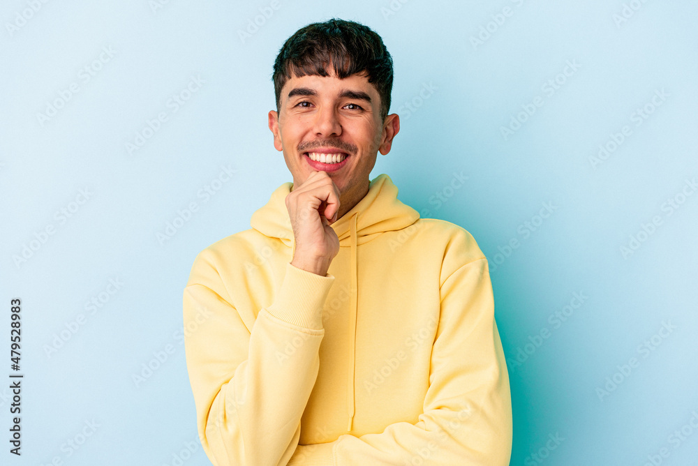 Young mixed race man isolated on blue background smiling happy and confident, touching chin with hand.