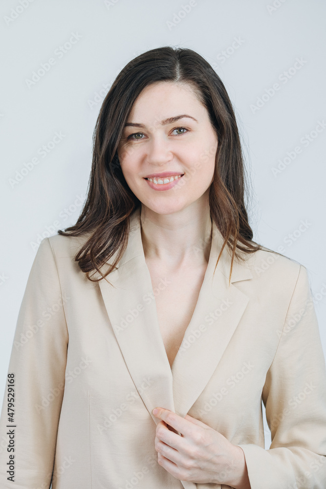Beautiful woman in a blazer raises her hand in greeting. Welcome new employees to the company. Business woman smiles and shows hand. Warm and cheerful lady boss Beautiful woman in a blazer raises her hand in greeting. Welcome new employees to the company. Business woman smiles and shows hand. Warm and cheerful lady boss