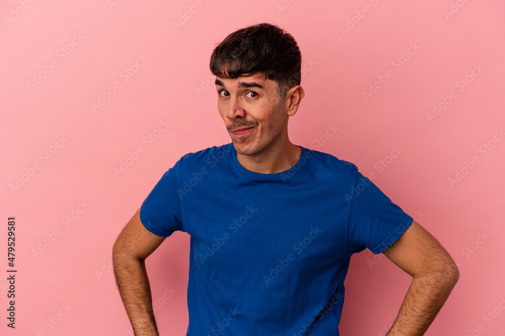 Young mixed race man isolated on pink background confused, feels doubtful and unsure.