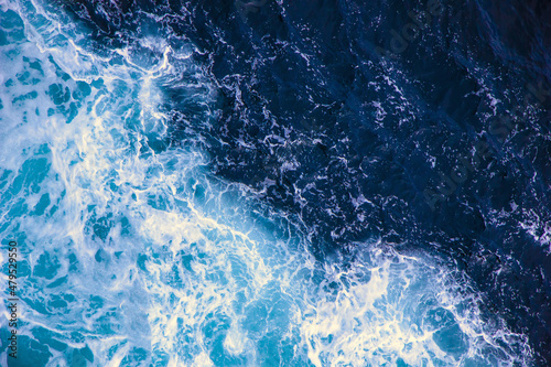 Surface of blue water with white foam  sea texture  ocean background