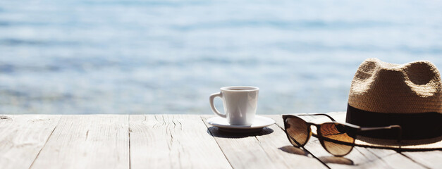 Cup of coffee on a table with beautiful sea view at the background. Travel, vacations, summer fun, enjoying life, relaxation, happiness, lifestyle concept. Panoramic banner