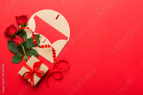 Fototapeta Naklejka Na Ścianę i Meble -  Valentine day composition with envelope, rose flower and red heart on table. Top view, flat lay, copy space Holiday concept