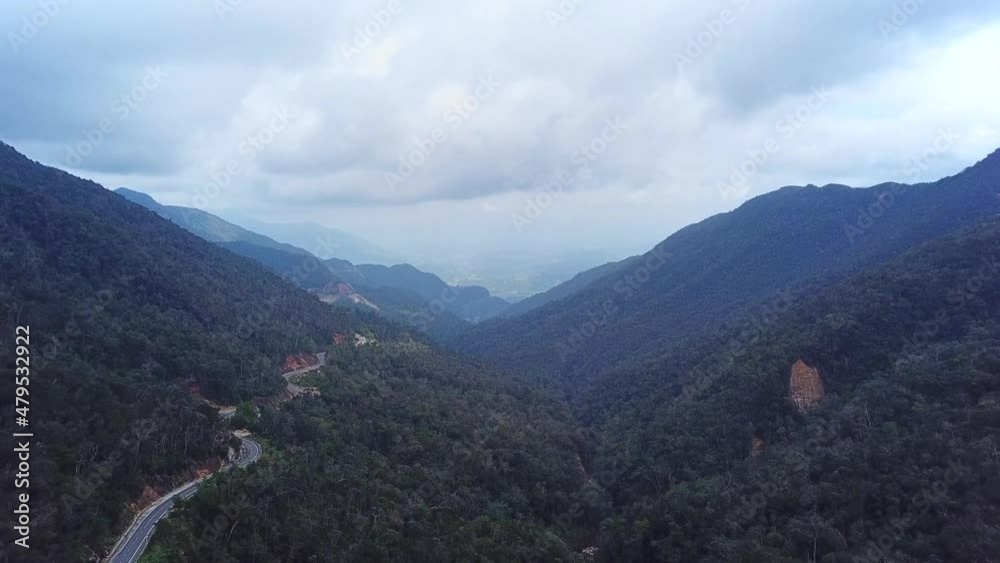 Drone flying above majestic foggy mountains landscape. Cinematic footage birds eye view tropical misty rainforest winding mountain road. Drone flying above majestic foggy mountains landscape. Cinematic footage birds eye view tropical misty rainforest winding mountain road.