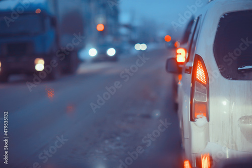 snowfall in city traffic jam in winter, background seasonal snow highway road