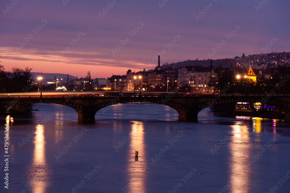 Prague at night, view of the Vlatava river, reflection of night city lights, cityscape