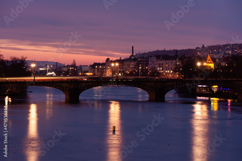 Prague at night, view of the Vlatava river, reflection of night city lights, cityscape