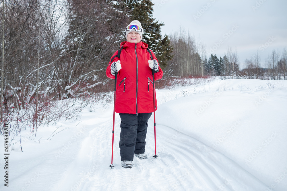Nordic walking in winter. Grandma goes in for sports.