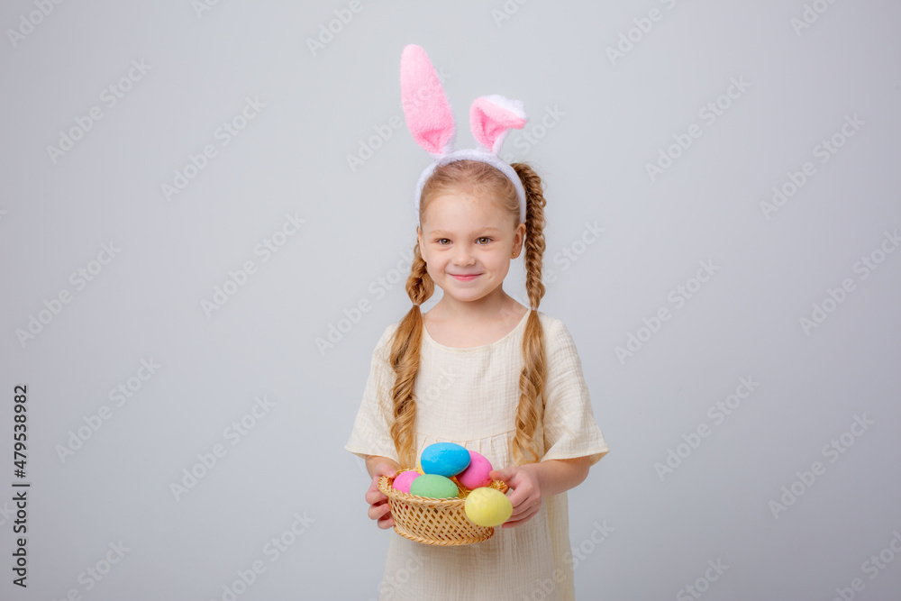 cute little girl with bunny ears easter egg basket on white background,