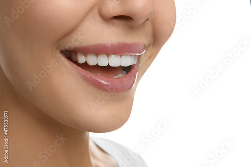 Young woman with healthy teeth on white background, closeup