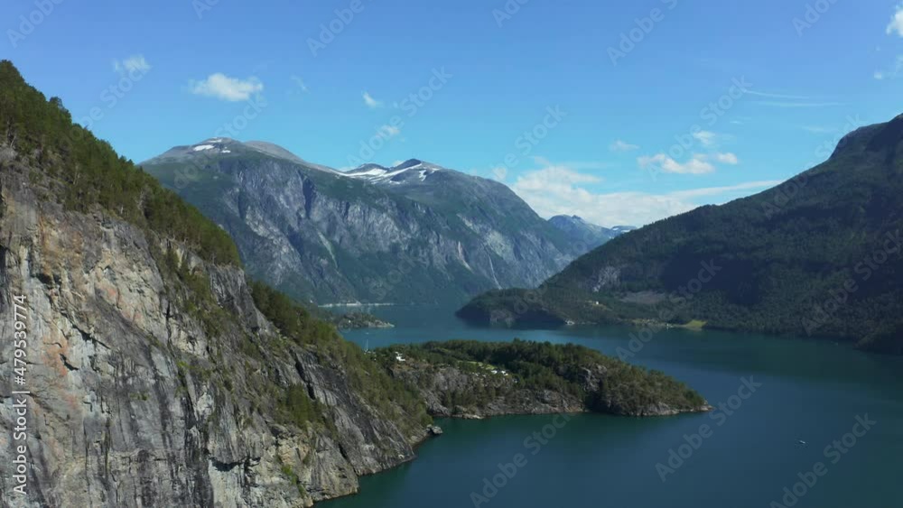Aerial view over the Storfjorden, in middle of high mountains, summer in Norway - circling, drone shot Aerial view over the Storfjorden, in middle of high mountains, summer in Norway - circling, drone shot