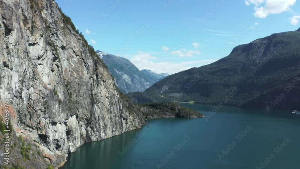 Aerial view passing a steep mountain wall in Storfjorden, Norway - rising, drone shot Aerial view passing a steep mountain wall in Storfjorden, Norway - rising, drone shot