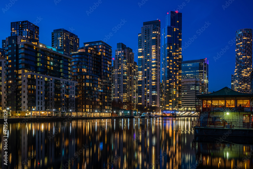 Evening view of Millwall Inner Dock with reflections in water, London UK
