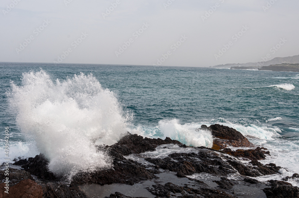 the sea stumbles over the rocks in its path