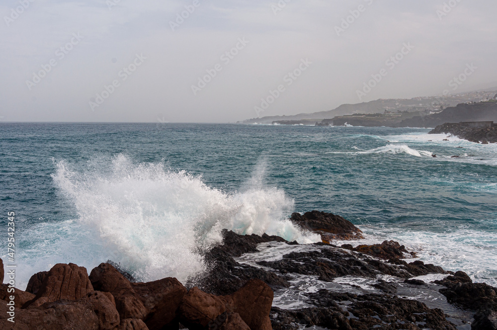 the sea stumbles over the rocks in its path