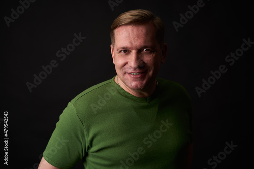 Handsome smiling middle aged man studio portrait © spaxiax