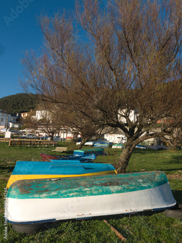 Fishing boats resting on land during winter. Bares village in the background.