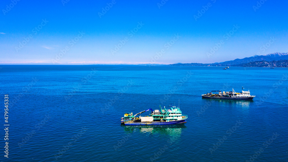 Batumi, Georgia - March 03, 2020: Fishing ships at sea, aero view