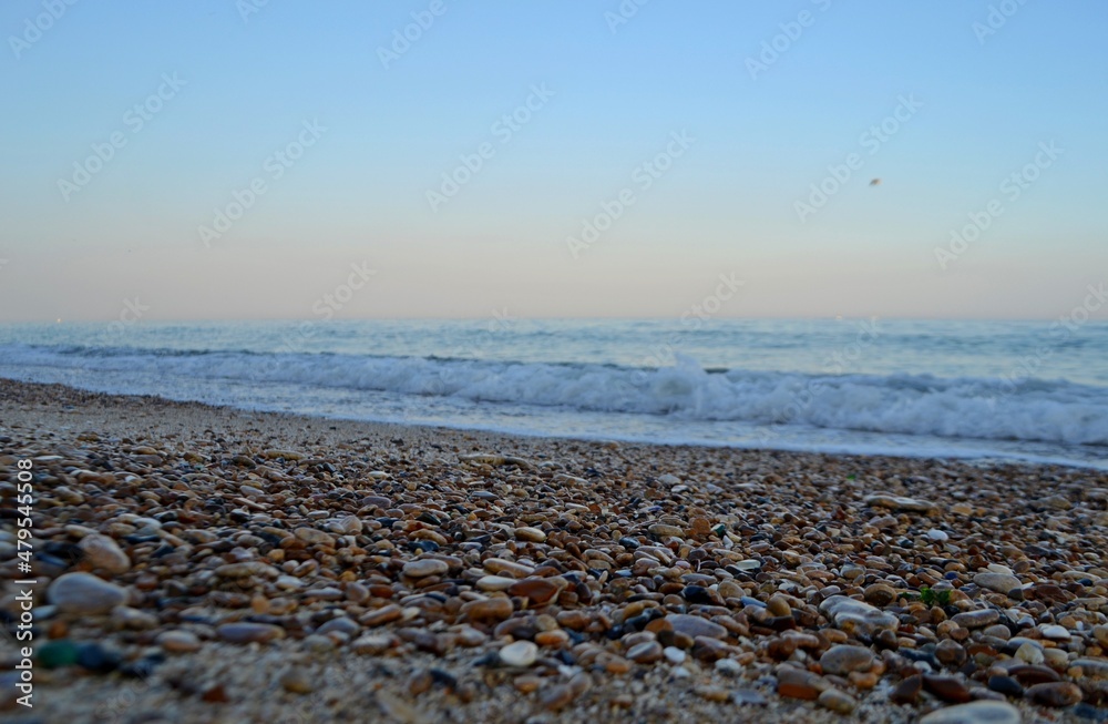 Sea pebbles on a wave background