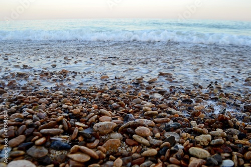 Sea pebbles on a wave background
