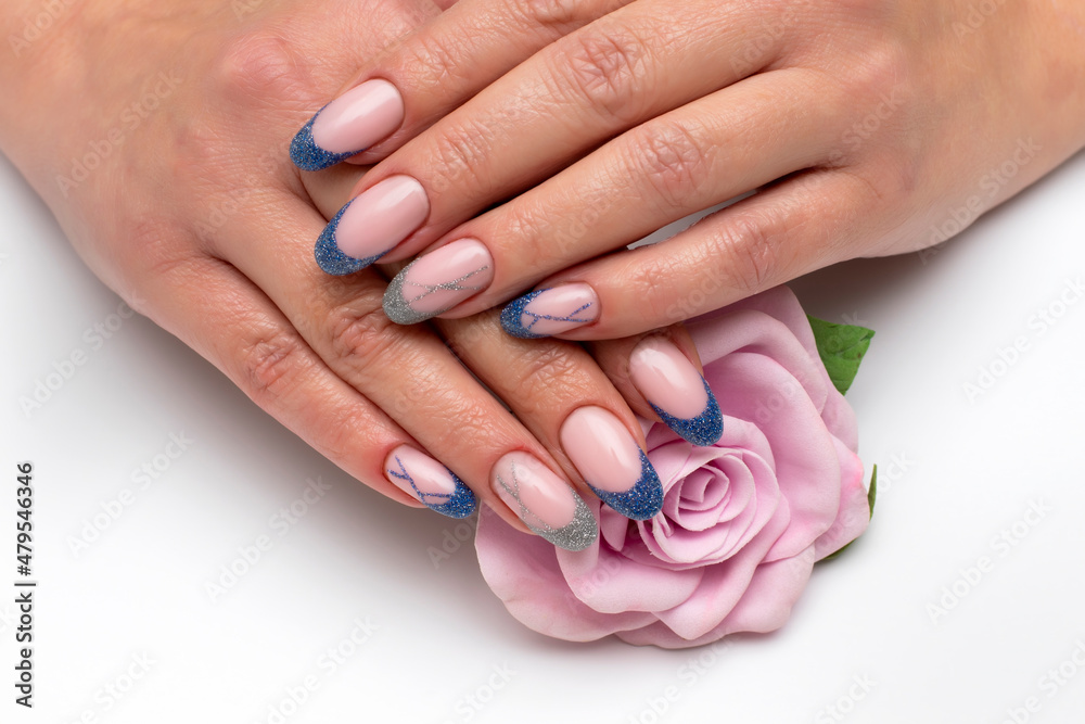 French blue, silver manicure on long oval nails with sequins with stripes with a pink rose in the palm French blue, silver manicure on long oval nails with sequins with stripes with a pink rose in the palm