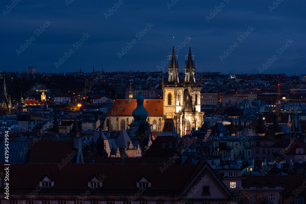 Prague in the evening, church lit with lights, cityscape