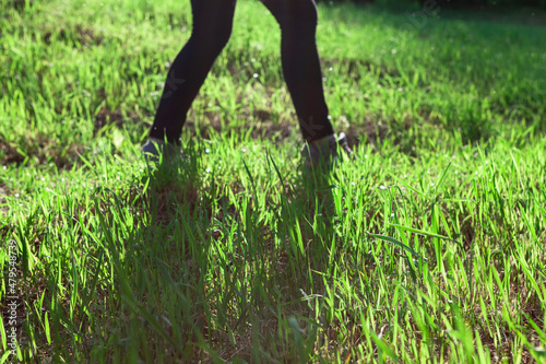 Legs silhouettes in the grass . Walking in nature