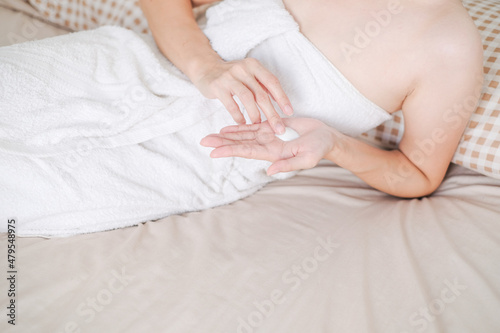 Woman applying natural cream, Woman moisturizing her hand with cosmetic cream, Spa and Manicure concept.