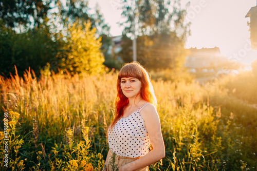 portrait of red hair girl on summer background