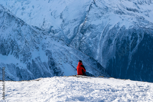 A man sitting at the edge of a rock