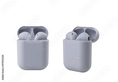 Two grey wireless headphones in a case on a white background © treerasak