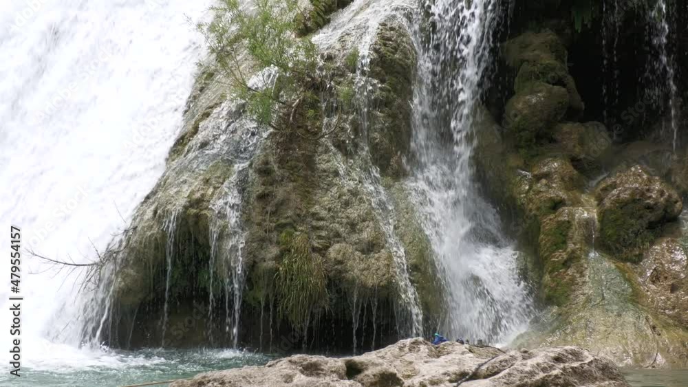 Steady shot, cropped view of waterfall cascading down to a pool below Steady shot, cropped view of waterfall cascading down to a pool below