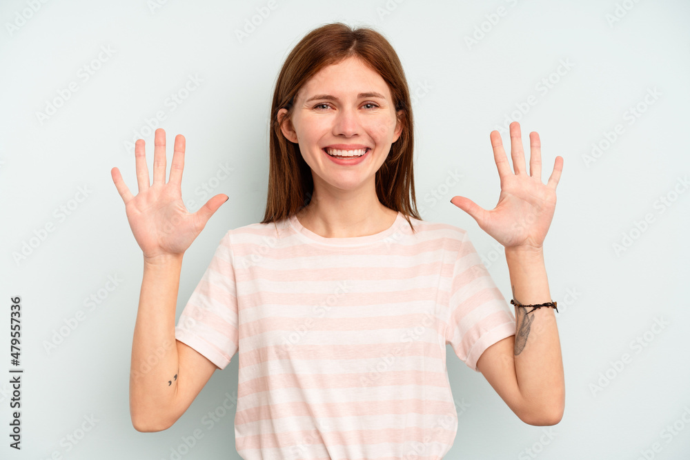 Young English woman isolated on blue background showing number ten with hands.